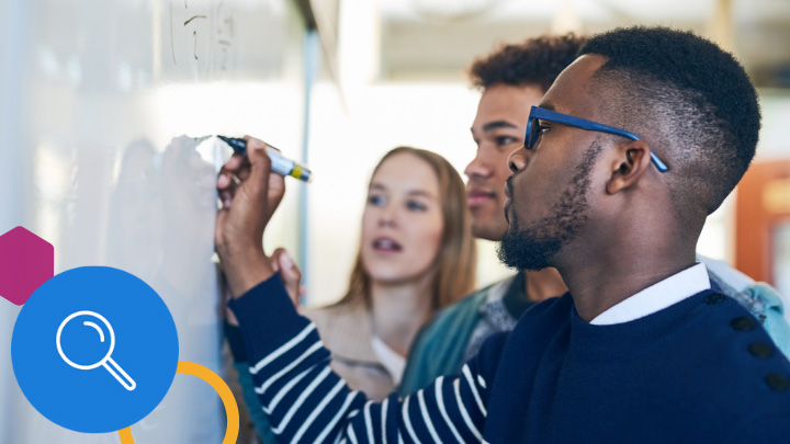 Teacher and high school students writing on whiteboard