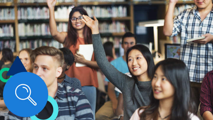 High school students raising hands in library