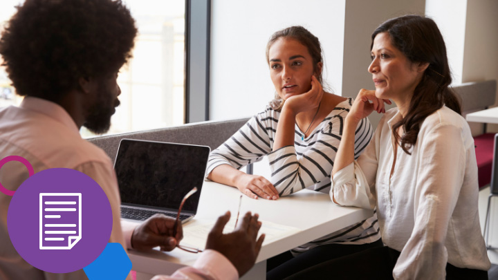 Three people talking to each other at table