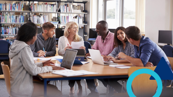 Group of teachers working together in a library