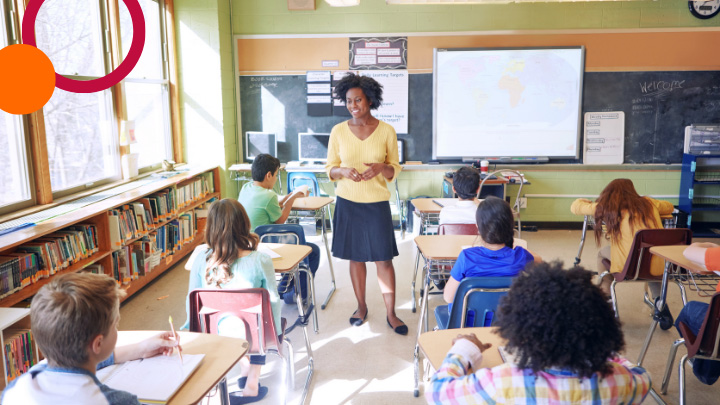 Teacher walking between desks in classroom