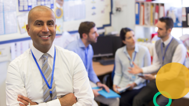 Teacher smiling in classroom.