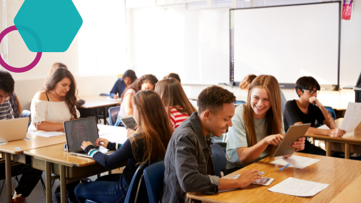 Students use devices in a classroom.