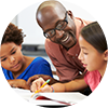 Teacher helping two students